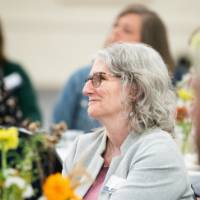 Audience members listening to speaker 5